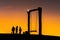Silhouette of happy young man and woman on hadubi hill and a swing with golden light sunset background. Hadubi viewpoint at Lao Wu
