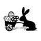 Silhouette of a hare with an easter cart with wheels filled with