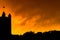 Silhouette of Harlem skyline, with the American flag waving in the wind, against a bright yellow fiery-looking sky