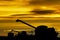 Silhouette of harvesting machines unloading soybeans