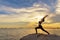 Silhouette healthy woman lifestyle exercising vital meditate and practicing yoga outdoors on the rock at beach sunset and twiligh