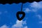 Silhouette of heart shaped wind chimes