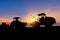 Silhouette of heavy wheeled tractor, grader, compactors and other construction machinery in the road construction site sunset