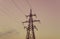 Silhouette of high metal electricity tower with wire. Sunset tim