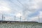 Silhouette of the high voltage electric pylon towers on the background of beautiful clouds