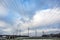 Silhouette of the high voltage electric pylon towers on the background of beautiful clouds