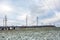 Silhouette of the high voltage electric pylon towers on the background of beautiful clouds. steaming pipes of a thermal power