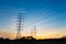 Silhouette high voltage electricity pylon on sunrise background