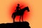 Silhouette of a horse and rider at sunset