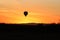 Silhouette of a hot air balloon during sunrise.