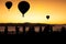 Silhouette hot air balloons floating over yun lai viewpoint, pai, thailand