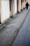 Silhouette of a human figure male youngster walking on the rads crossing the leadings lines of wall.Minimalistic view.