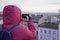 Silhouette of a human with a phone on the background of the city. tourists, autumn walks with photos in the cities. photo from the