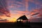 Silhouette hut at sunset.