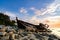 Silhouette image of abandon shipwrecked on rocky shoreline. dark cloud and soft on water