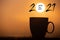 Silhouette image coffee cup with text happy new year 2021 on a sunrise background