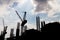 Silhouette image of construction site against blue sky