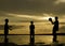 Silhouette image happy boys playing beach soccer at dawn time with beautiful sunrise background