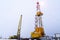 Silhouette image of oil and gas drilling rig in the middle of nowhere with dramatic sky. Onshore land rig in oil and gas industry