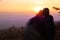 Silhouette images of men and women closer together. Sitting on the hillsides to scenic sky in the morning is beautiful with love