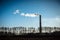 Silhouette of industrial factory smoke stack of coal power plant from chimney up on sky cause air pollution and destroy the Earth