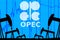 silhouette industrial oil pump jacks and oil graph with OPEC logo