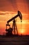 silhouette of industrial oil pump at sunset, fuel rig derrick, energy and power supply concept