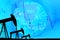 Silhouette industrial pump jack and falling oil graph on the blue globe background