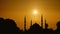 Silhouette islamic mosque with dome and two tower with background of sunrising