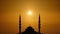 Silhouette islamic mosque with dome and two tower with background of sunrising