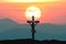 Silhouette Jesus and cross over sunset on mountain top with copy space