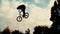 Silhouette of jumper, performing BMX mountain bike