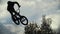 Silhouette of jumper, performing BMX mountain bike