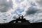 Silhouette of kid and her father sitting on car roof enjoying with beautiful nature while traveling with car