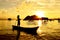 Silhouette of a kid paddling on a boat