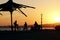 A silhouette kids with bikes on the beach during sunset