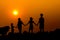 Silhouette of kids playing together with sunset