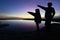 Silhouette of kids pointing in a beautiful sunset