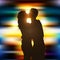 Silhouette of a kissing couple on beautiful city lights