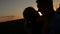 Silhouette of a kissing couple in love at sunset.