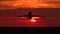 Silhouette of large passenger airplane taking off against orange sunset