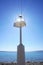 Silhouette of light signal station or lighthouse by the seacoast with sun ray reflection and blue sky and sea in the background