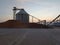 Silhouette light wood chips silo and stack of wood yard factory and industry engineering construction