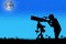 Silhouette of little boy looking through a telescope