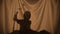 Silhouette of little boy telling spooky stories using shadow play and paper bats. Child of primary age spend leisure