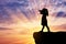 Silhouette of little girl child standing on top looking through binoculars