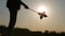 Silhouette of the little girl together with pinwheel windmill.