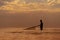 Silhouette of local fisherman finding shrimp by using traditional nets at sunrise