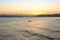 Silhouette of a lone canoeist paddling in Santos Bay during sunset