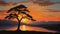 Silhouette of a lone tree against the canvas of a vivid sunset